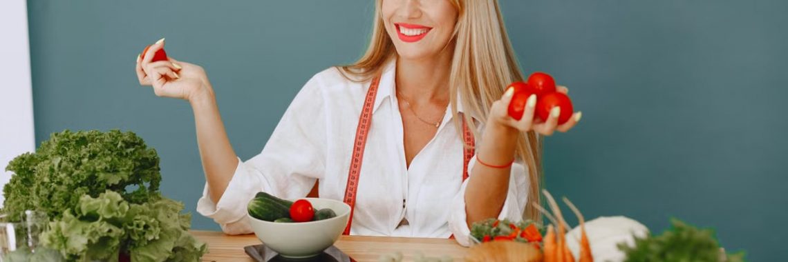 Healthy lifestyle concept with woman holding tomatoes and surrounded by fresh vegetables in a studio setting.